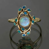 Anillo retro azul con cristales y ópalo